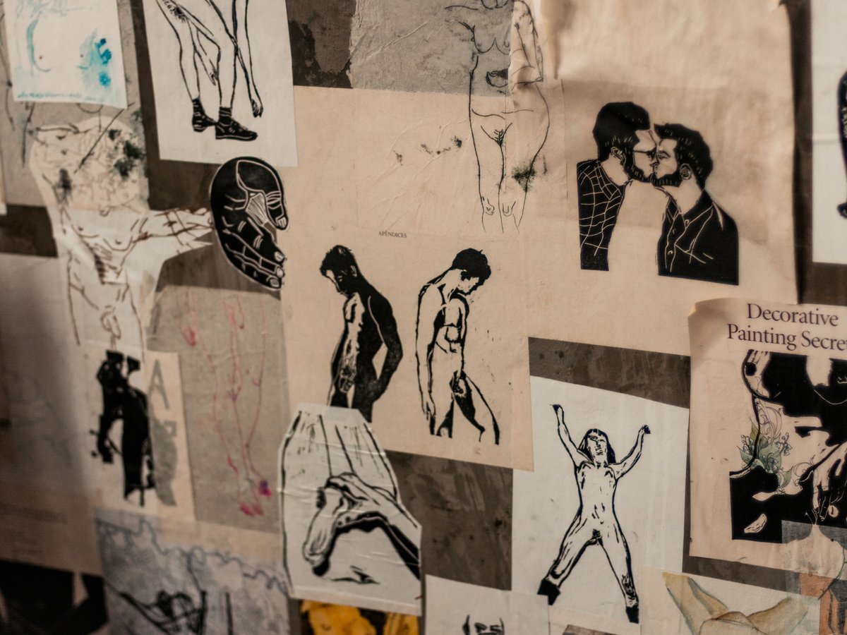Wall of drawings and prints of male figures