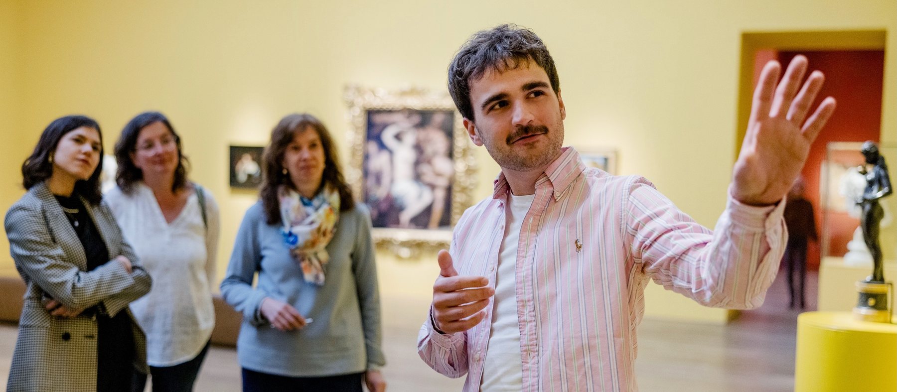 Gordon Prager guiding a small group through a museum